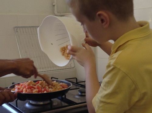 We fried the onions in a pan and then added other ingredients such as fresh tomatoes, garlic and chickpeas. Nicely done Theo!