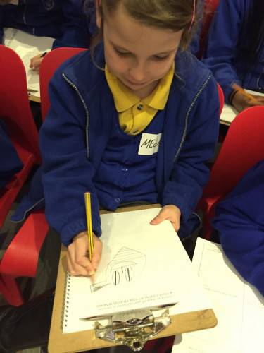 Megan shows full concentration when creating her own comic book character. 