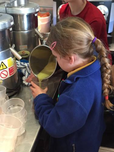 Megan carefully pours her Apple juice ready to be served!