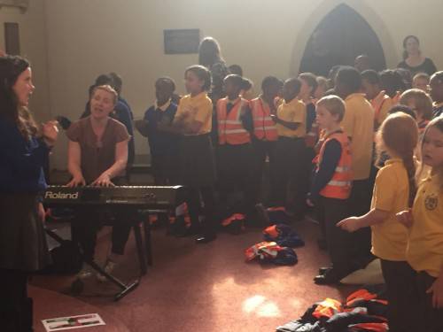 Children sing 'Don't tell Mr Scarecrow!' and 'Big Red Combine Harvester" as they lift the roof off St Mark's Church. 